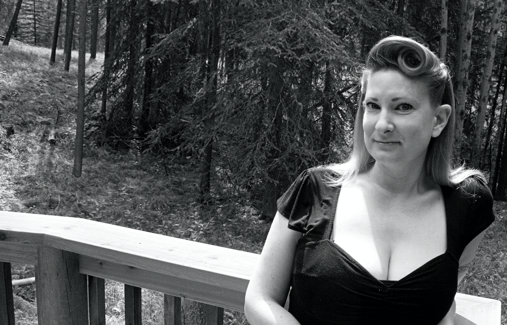 Black and white picture of Sierra Skye Gemma leaning against a railing with a forest in the background